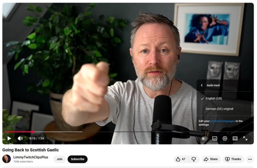 A screenshot of a youtube video of streamer Limmy talking to the camera, showing youtube's auto-dub feature thinking that he is speaking German
