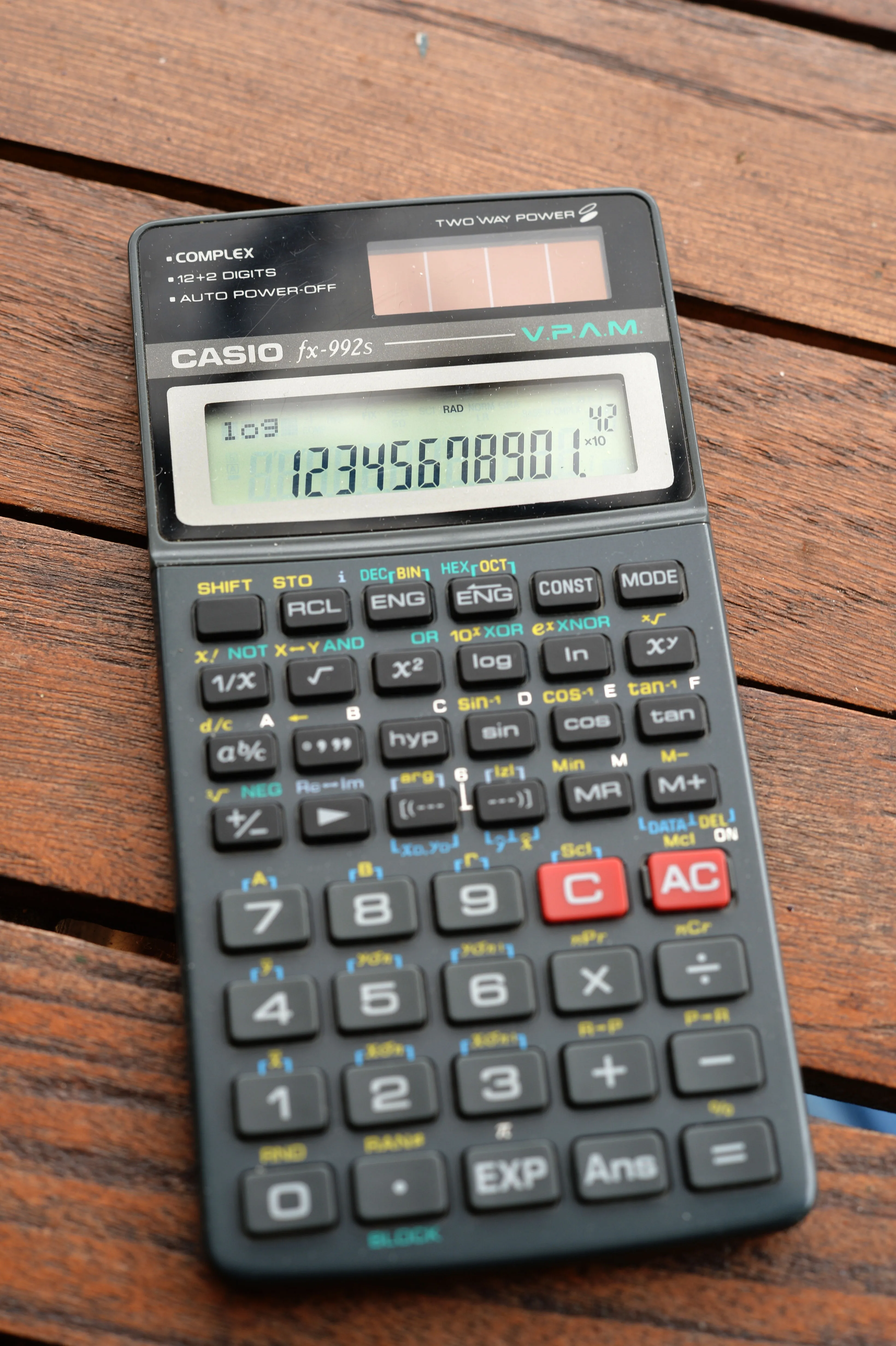 Casio fx-992s, a scientific calculator from the late 1990s.  It was the peak design before the W series moved to two lines.  Unusually, it also calculated to 12 digit precision.  It's a dark grey good looking machine with tall 7 segment LCD figures and small dot matrix displays in the top left and bottom right.