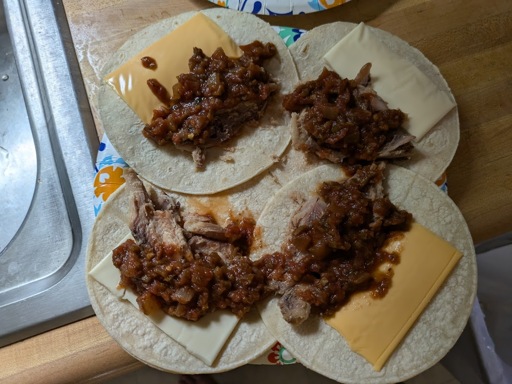 sardines on tortillas with salsa, cheese and hot sauce. mmm