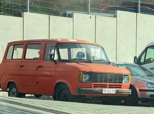 A red Ford Transit, 3rd Generation (1978–1985), with a black-on-white license plate reading UR 36278.