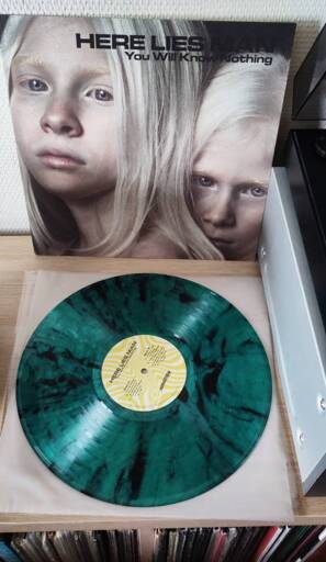 Cover is leaning against the wall next to my turntable. In front the vinyl is laid out on top of the inner sleeve.