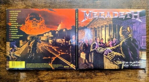 Cover of Megadeth's "The System Has Failed" showing a line of politicians getting cash handouts from death