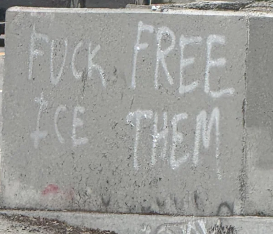 Graffiti on a wall, saying "Fuck ICE, FREE THEN"