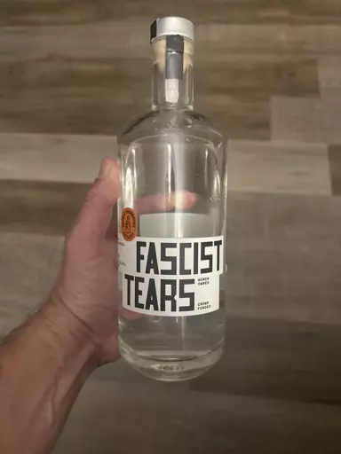 A bottle of alcohol labelled "Fascist Tears"