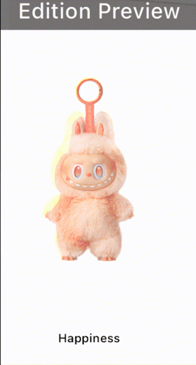 white background image with three heavily vertically spaced-out elements: a double–gif-compressed image of a rose-colored luobubu—a menacing chinese "cute" fluffy doll that vaguely resembles chucky; at the top is white text on grainy grey background "Edition Preview"; and at the bottom is clear sans-serif text saying "Happiness". You will find happiness here, dear customer.